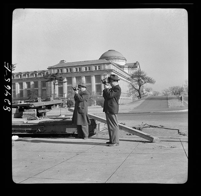 Washington D.C. News photographers making movies. Transplanting a tree on emergency office space construction job. Photo by John Collier.