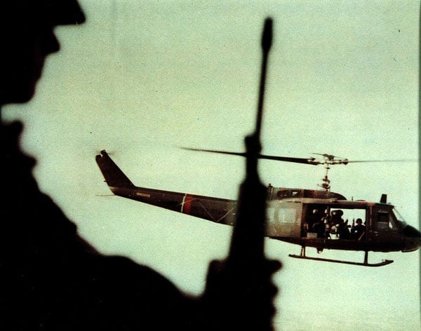 On the Attack, 1966. A helicopter transports members of the U.S. Army 25th Infantry Division to the Cambodian border. Photo by Sergeant First Class Alfred “Bat” Batungbacal, U.S. Army.