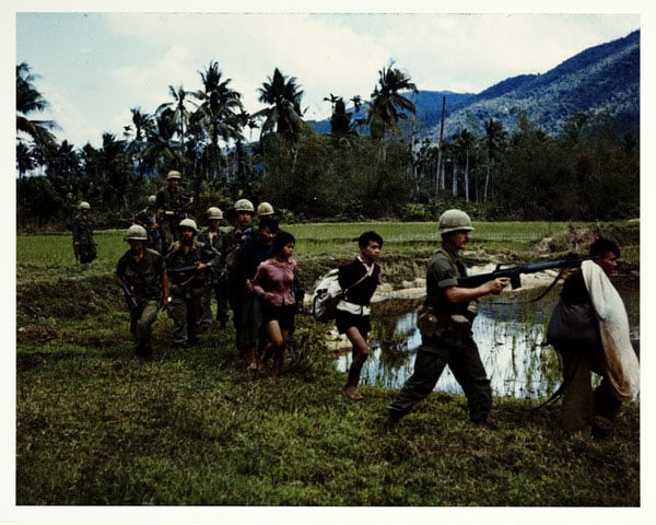 Captured, 1967. Members of U.S. Army 1st Cavalry Division return to base camp in the An Lao Valley with Viet Cong prisoners. Photo by Specialist 5 Robert C. Lafoon, U.S. Army.