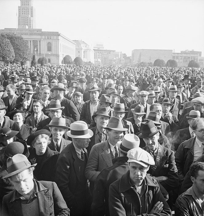 Listening to speeches at mass meeting of Works Progress Administration (WPA) workers protesting congressional cut of relief appropriations. San Francisco, California. February 1939.