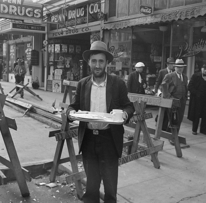 Salvation Army, San Francisco, California. In the neighborhood where the Salvation Army operates. Breakfast for his pal, bummed from a restaurant. April 1939.