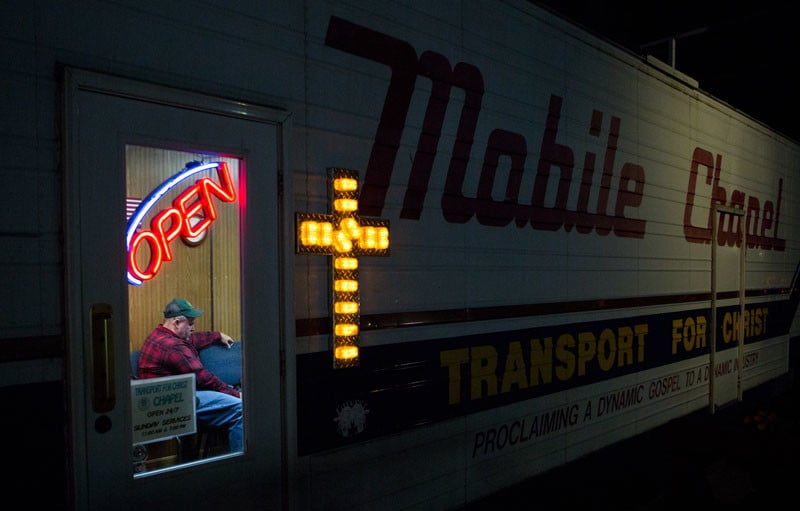 Trucker Chapel by Lauren Pond of Columbus, Ohio , United States "Truck driver Ben Blackburn, 46, participates in a Bible study session at the Transport For Christ (TFC) mobile chapel in Lodi, Ohio, on October 23, 2013. TFC chaplains helped Blackburn enroll in trucking school after he lost his job during the recent economic recession. Transport For Christ, an international trucker ministry, has placed 45 mobile chapels at truck stops across the United States. The chapels offer Bible study, worship services and counseling from volunteer chaplains. They also give drivers a break from the struggles and solitude of life on the road."