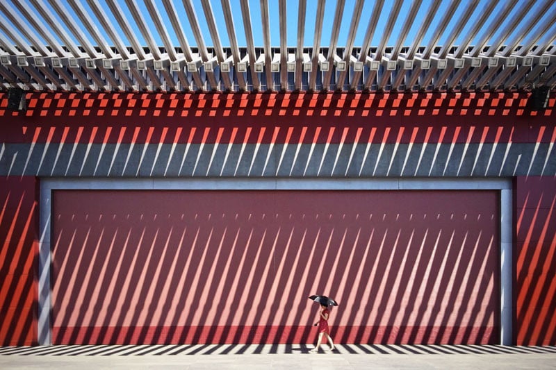 The China Red by Jian Wang of Beijing, China "In front of this Chinese red wall walks a lady in a red dress."