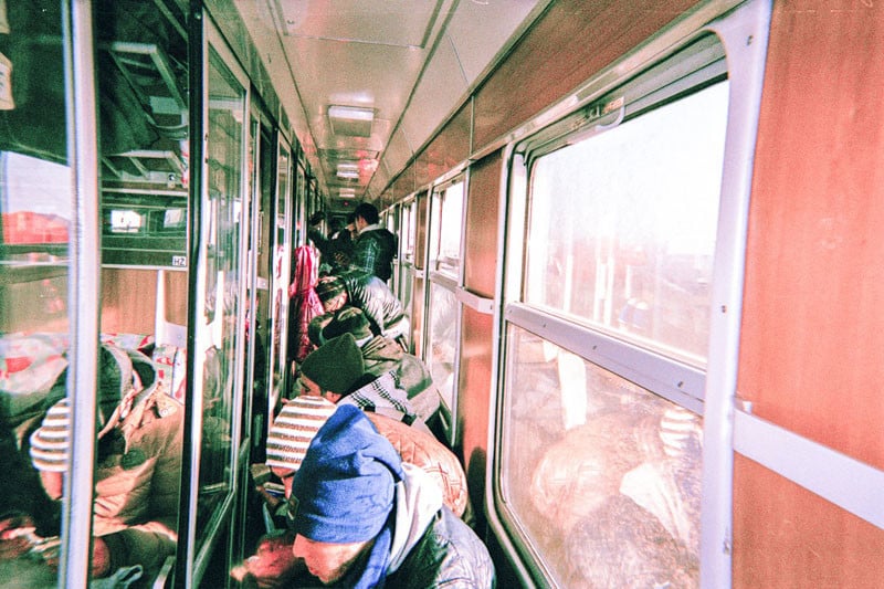 Refugees sit on the floor in an overcrowded train in Germany