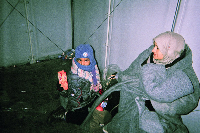 Son Kerim and Dyabs' wife in a transfer-camp are covered in blankets in a transfer camp in Macedonia.