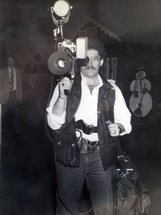 Osterreicher carrying an old RCA TK-76 TV camera. He is also seen carrying a Sony VO-4800 ¾ inch u-matic video recorder. Two battery belts were required to power the camera and the 250watt light (on top of the camera). Circa 1983.