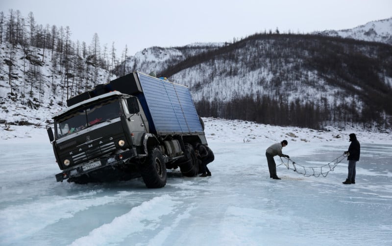 After seeing two places where trucks had recently plunged through the ice, we almost went through ourselves. After the chains were attached Ruslan managed to scrape back out of this situation and continue on.