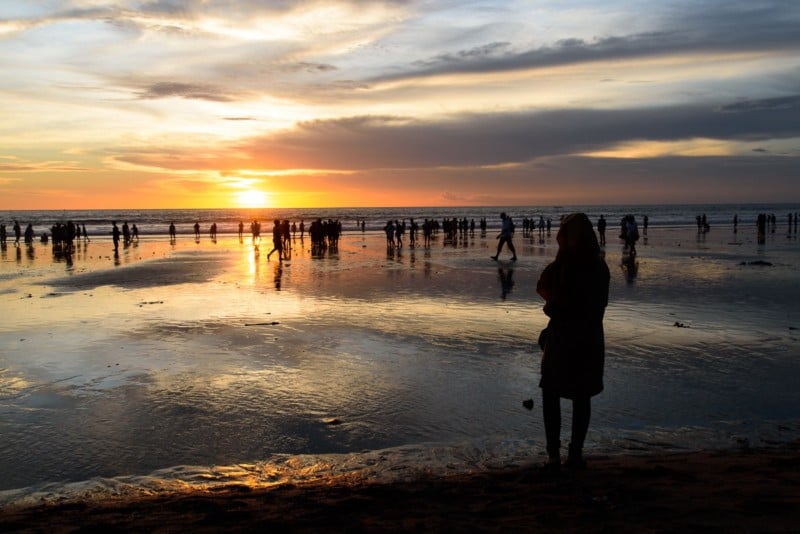 People watching the sunset on one of the beaches in Kuta, Bali, Indonesia.