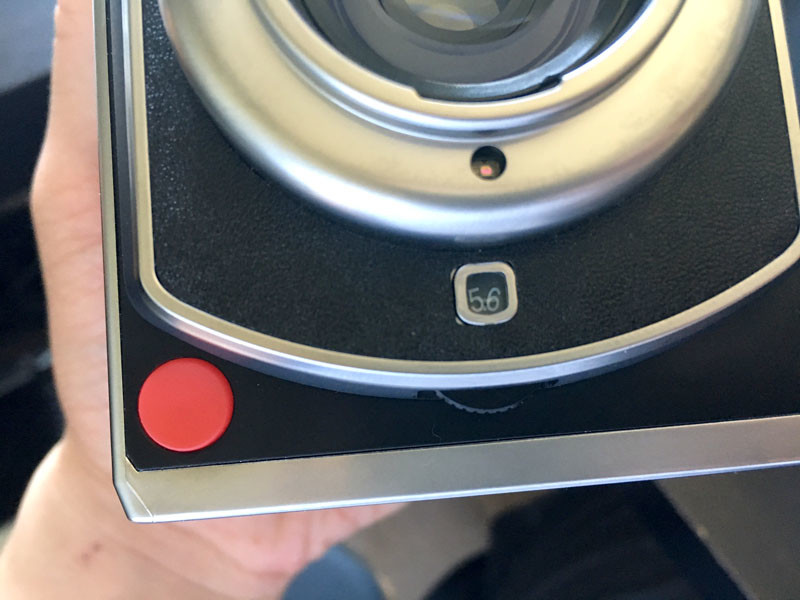 The red shutter button and the aperture selection wheel.