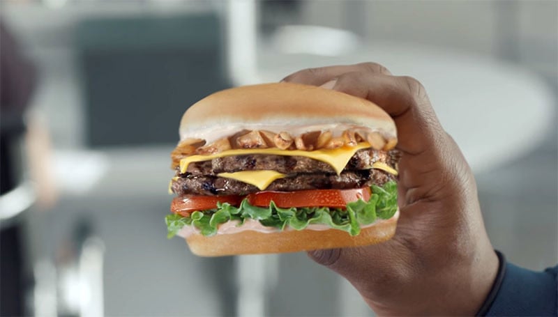 This Hilariously Bad Carl S Jr Ad Shows A Guy Eating A Photo Of A Burger Petapixel