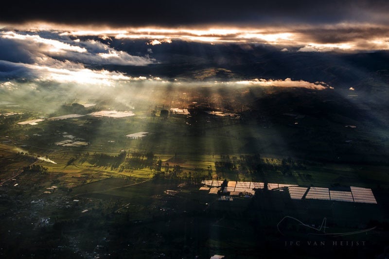 Rays of sunlight streaming through clouds in Latacunga, Ecuador.