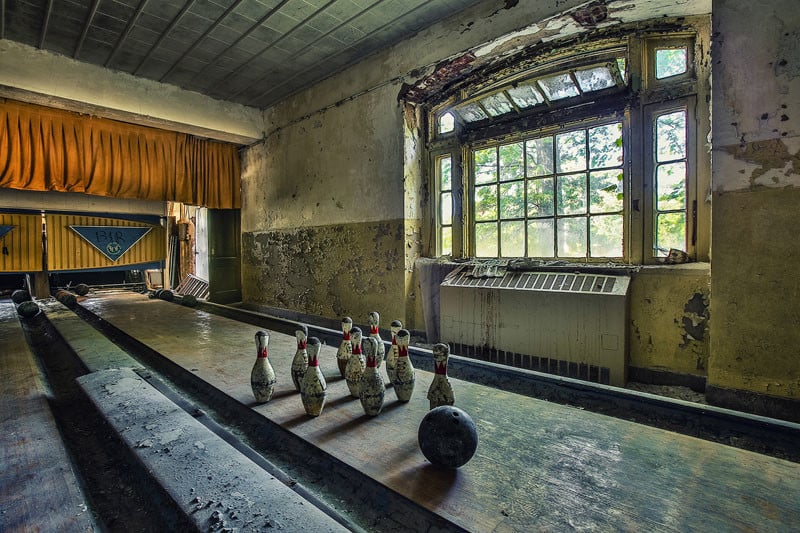 An abandoned bowling alley in a Psychiatric Hospital. Most insitutions had recreation buildings with theaters, bowling alleys, game rooms, pools, etc.  