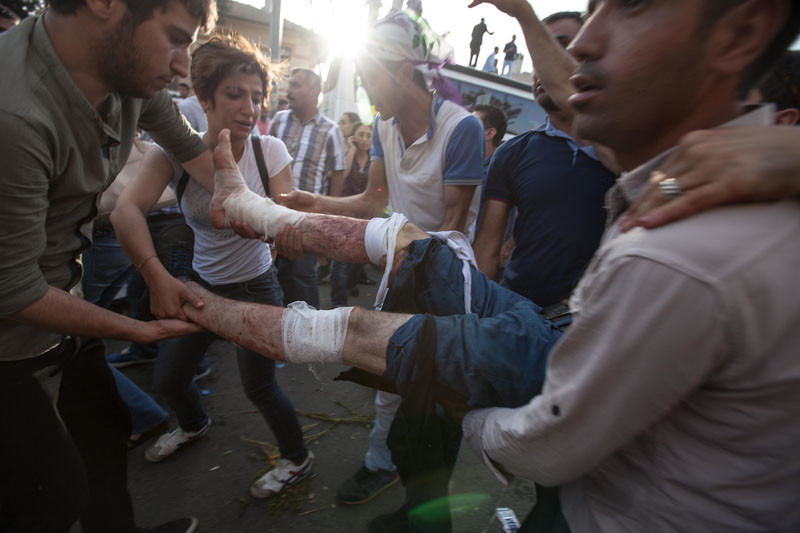 Two bombs went off in the crowd in Diyarbakir, Turkey, five people were killed and more than 400 injured were carried to ambulances. Violent attacks against Kurdish people are a motor behind displacement in the region. Under Informed Consent rules, the photographer would need to approach each of the people in the photograph to let them know how their images might be used. While it is feasible to do that, in this instance it would have had to be done in an ambulance, a Kurdish/English interpreter would be needed, and the unfolding of events around this scene would have been missed. Photo by Sean Hawkey.