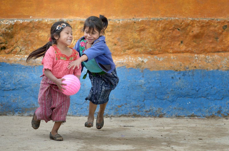 Girls play basketball during a 2014 recess from school in Tuixcajchis, a small Mam-speaking Maya village in Comitancillo, Guatemala. Under "informed consent" rules that require prior approval, the photographer would have had to stop the girls from playing, have them identify their parents, explain the intricacies of "informed consent" and usage, get their signature, and then be able to photograph the girls. That's a process that's allegedly designed to assure that the girls are not depicted in an undignified manner. Photo by Paul Jeffrey.