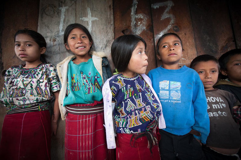 Maya Ixil children during a meeting in Turanza, Nebaj, Guatemala. People had gathered to share experience and learning on food security and nutrition in the region. Under Informed Consent rules, the parents of the children would have to be tracked down to give their consent for this photo to be taken or used. The assumption is that without informed consent, the photograph shows the children in an undignified way, or it puts them in danger. Photo by Sean Hawkey.