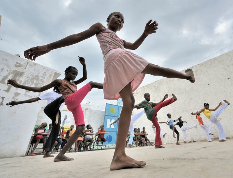 Children practice capoeira on January 24, 2010, in a camp for homeless families in the Belair section of Port-au-Prince. The program, run by Viva Rio, a Brazilian nongovernmental organization, is designed to help children affected by the quake recover their emotional well-being. Under "informed consent" rules that require prior approval, the photographer would have had to stop the girls from playing, go with them to find their parents, explain the intricacies of "informed consent" and usage, get their signatures, then return to the community center to photograph the activity. That's a process that's allegedly designed to assure that the children are not depicted in an undignified manner. Photo by Paul Jeffrey.