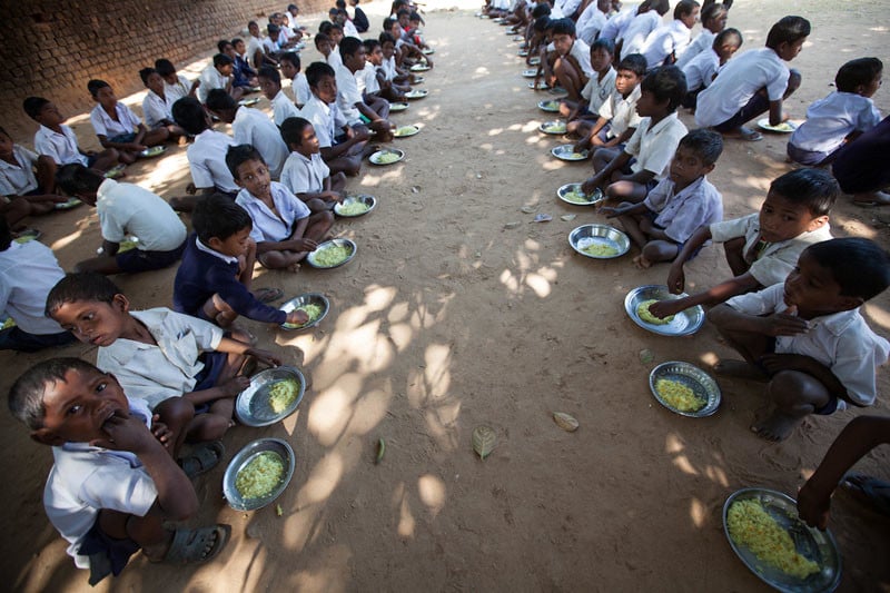 Dinners in this school near Ranchi in Jharkhand province, India, are subsidised by an aid agency working on nutrition and health. Under Informed Consent rules, the parents of the children in the picture would all have to be talked to in order for them to give their consent for this photo to be taken or used, it's not feasible to do that. Photo by Sean Hawkey.