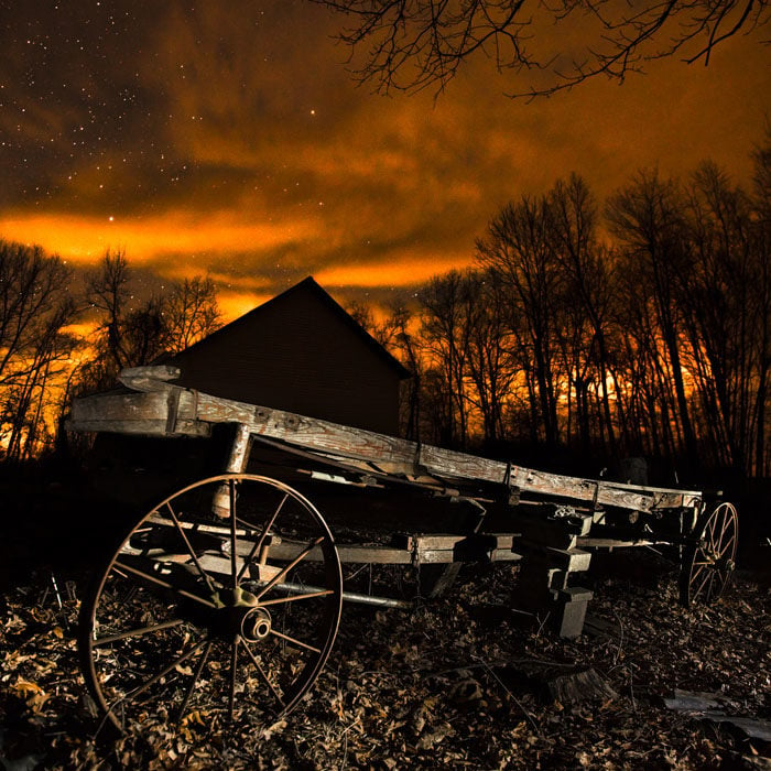 The wagon here was lit by quickly shining a flashlight over for just a few seconds during the exposure. The camera settings were: ISO 800, f/2.8, 20 secs.