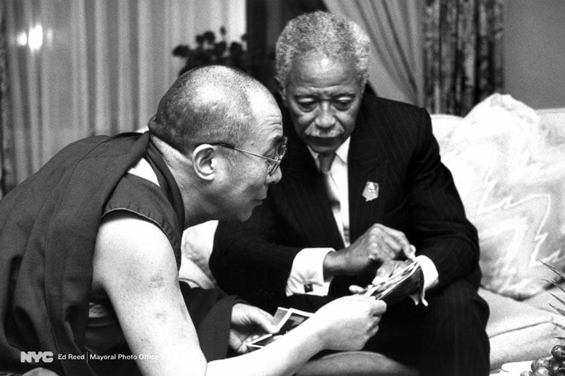 Sept. 11, 1990. Mayor David Dinkins shows family photos to the Dalai Lama in a courtesy meeting at a midtown hotel.