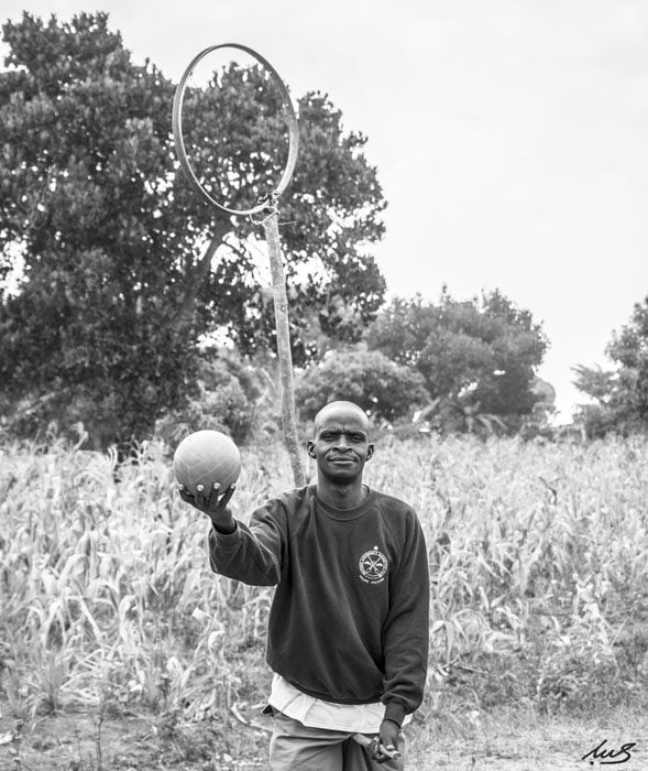 John Ssentamu holding a broomstick and a "bludger" ball 