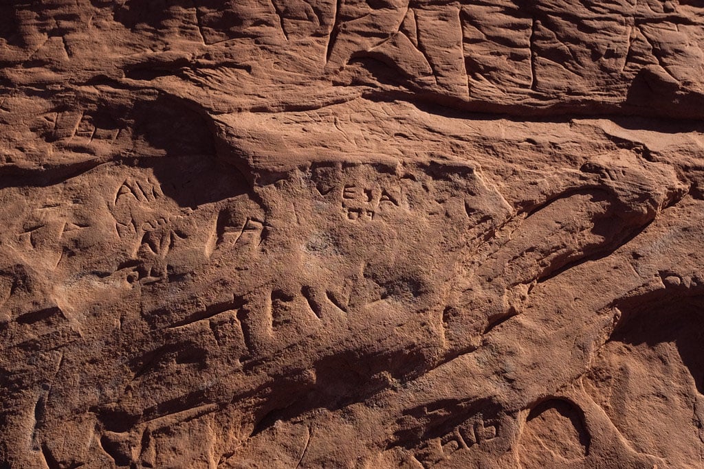 Initials and drawings carved into the rocks at Wilson Arch, just outside Moab, UT. Apparently Jesus (bottom) was here, but I doubt he'd condone anybody ruining his dad's hard work.