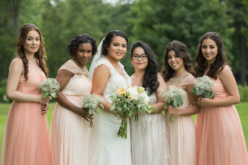 Bridesmaid poses in friend's wedding photos wearing a breast pump and AMEN  SIS | body+soul