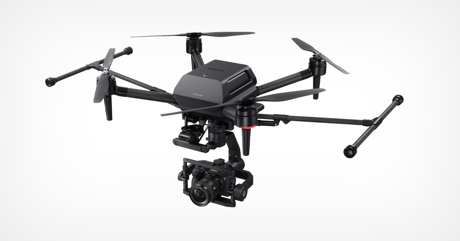 A black quadcopter drone with four propellers and a mounted camera underneath, set against a plain white background.