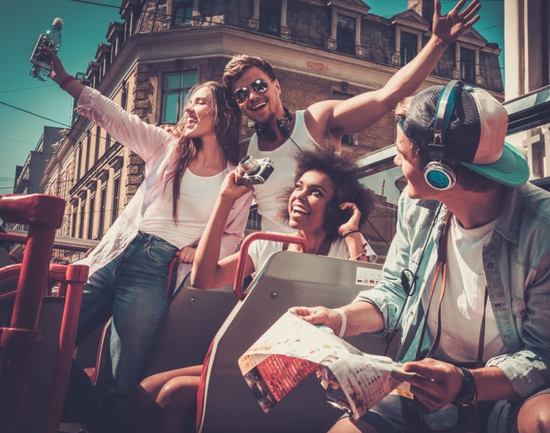 Multinational friends riding on a sightseeing bus