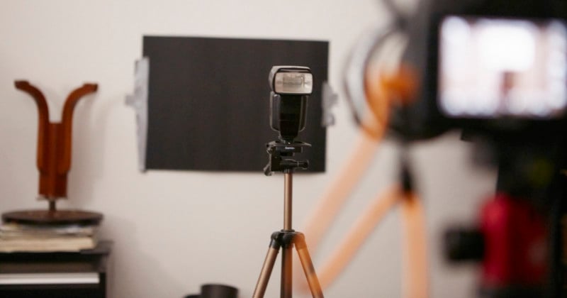 A photo of a flash on a tripod being used in a product photo shoot