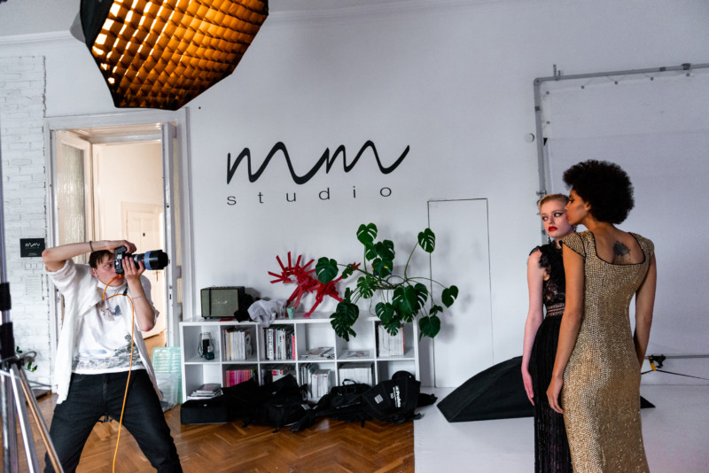 A photo shoot in which a man is photographing two women