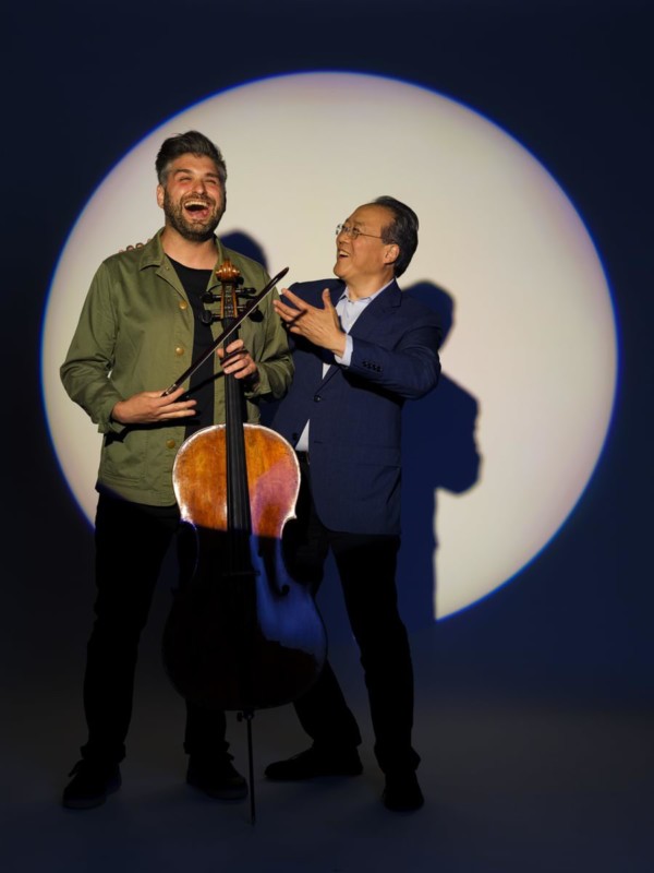 Cellist Yo-Yo Ma joking with photographer Drew Gurian