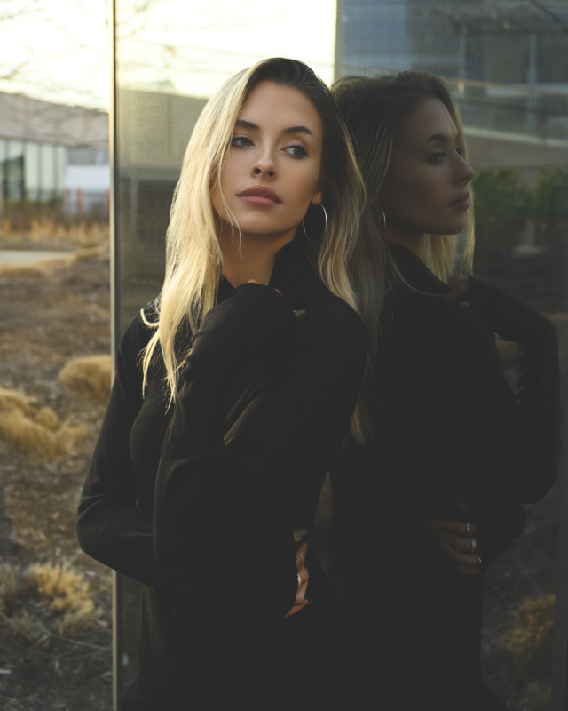 A portrait of a woman against a reflective background