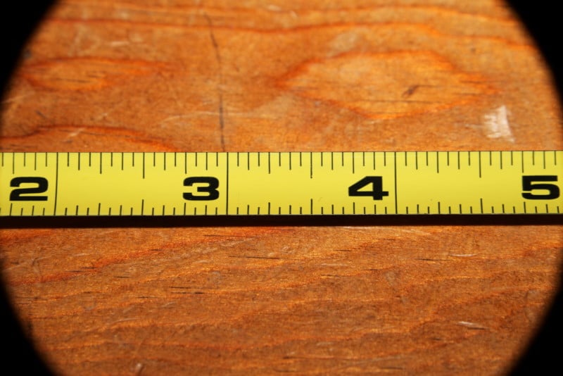 A close-up photo of a tape measure on a wooden surface