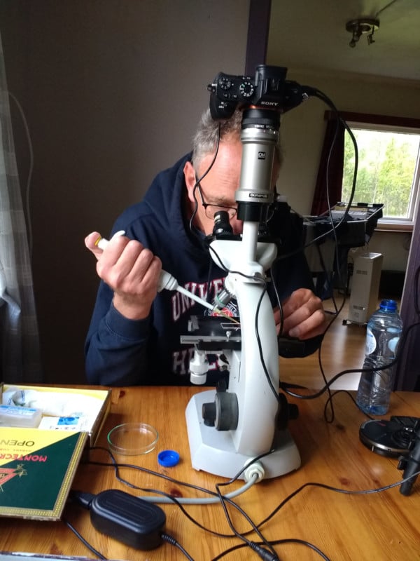 Jan van IJken using a microscope to photograph plankton