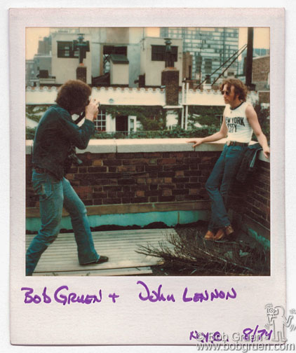 Polaroid of Bob Gruen taking a photo of John Lennon wearing NYC t-shirt on rooftop, NYC. August 29, 1974. © Bob Gruen