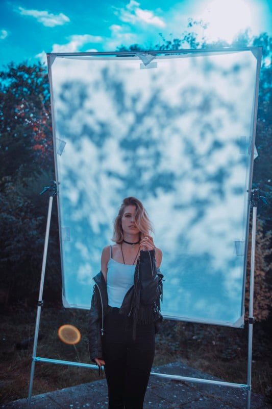 A woman posing against a do-it-yourself backdrop for dappled natural light