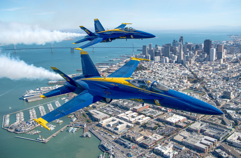 Lt. Ryan Chamberlain (below) and CDR Frank Weisser (above) fly U.S. Navy Blue Angels numbers 5 and 6 over San Francisco, California as part of a practice run for Fleet Week on October 06, 2016. On June 02, Capt. Jeff Kuss, pilot for Blue Angel Number 6, was killed during a "Split S" maneuver ahead of an air show in Tennessee. 