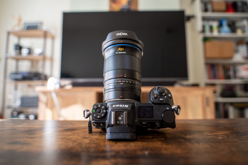 The Laowa Argus 45mm f/0.95 FF mounted on a camera and sitting on a table