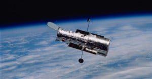 The Hubble Space Telescope as seen from space with Earth in the background