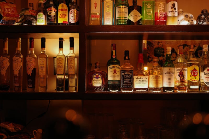Photo of wine and spirits behind a bar.