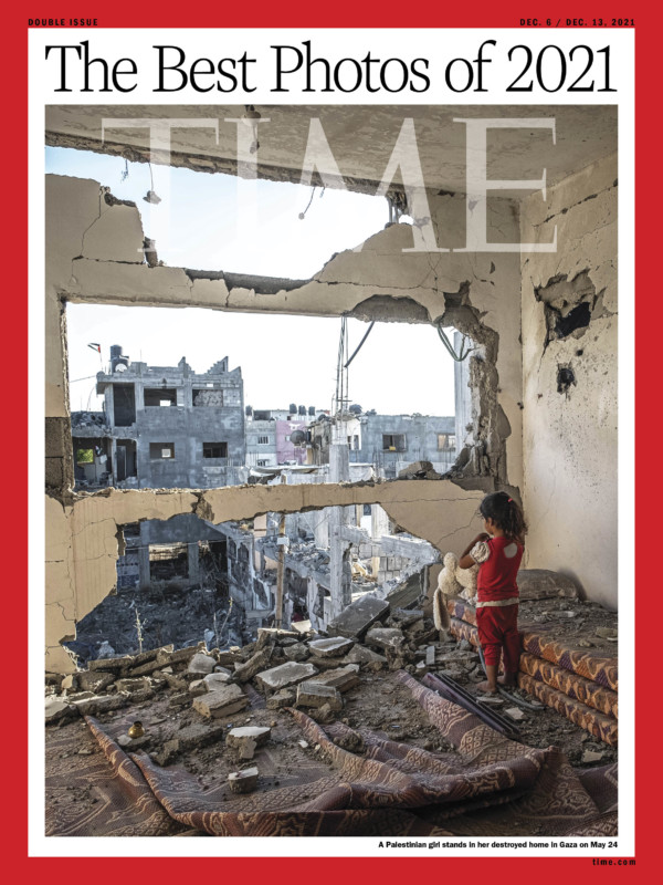 A Palestinian girl stands in her destroyed home in Gaza 