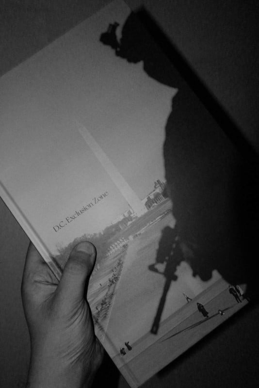 A hand holding a photo book