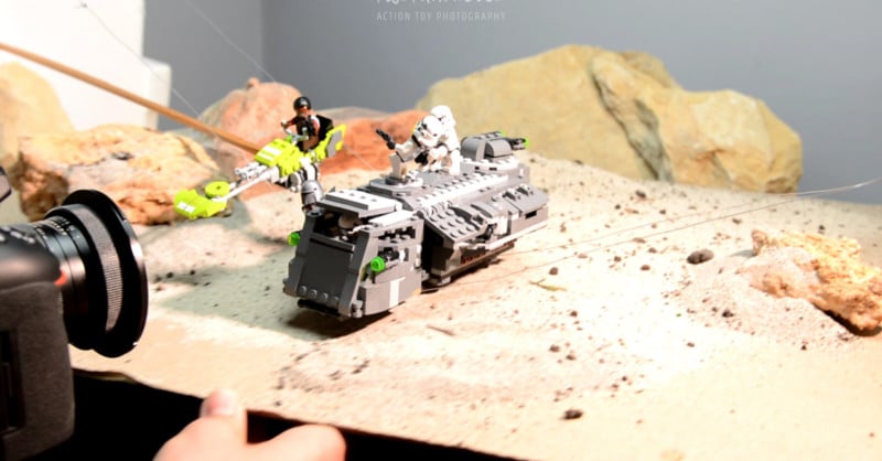 A photographer creating a Star Wars scene with LEGO