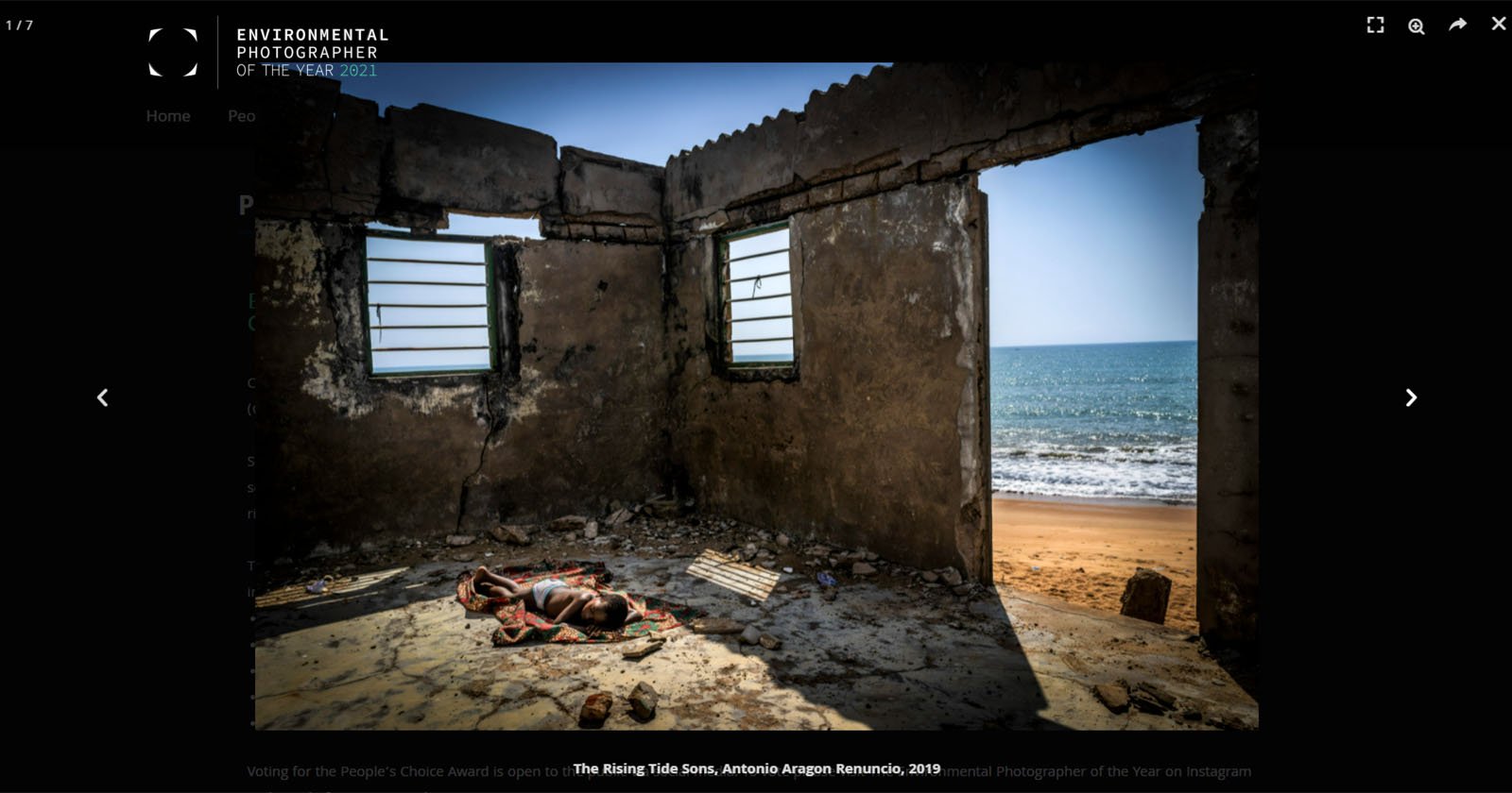 A photo contest-winning image showing a boy sleeping in an abandoned building on a beach