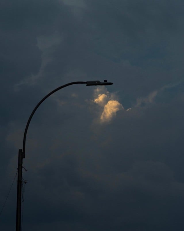 A spot of clouds illuminated below a street light