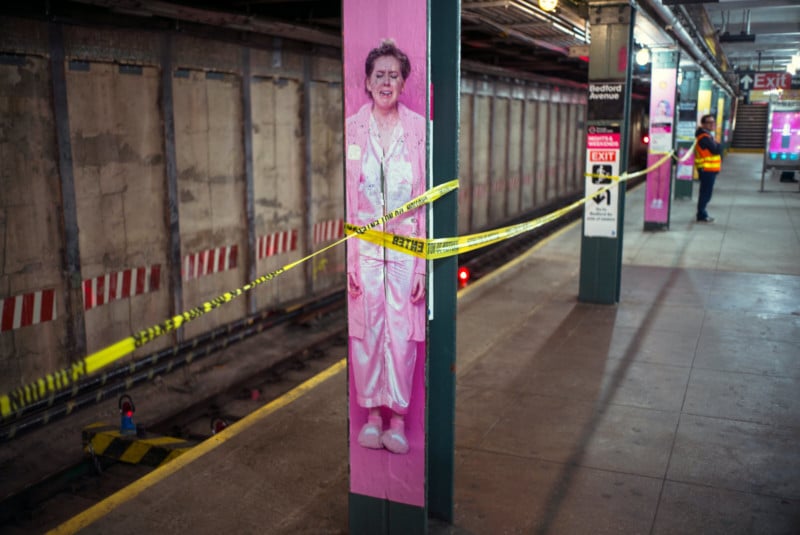 An advertisement of a person in a subway wrapped in caution tape
