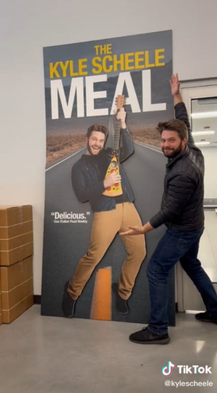 A man standing next to a giant cardboard cutout of himself