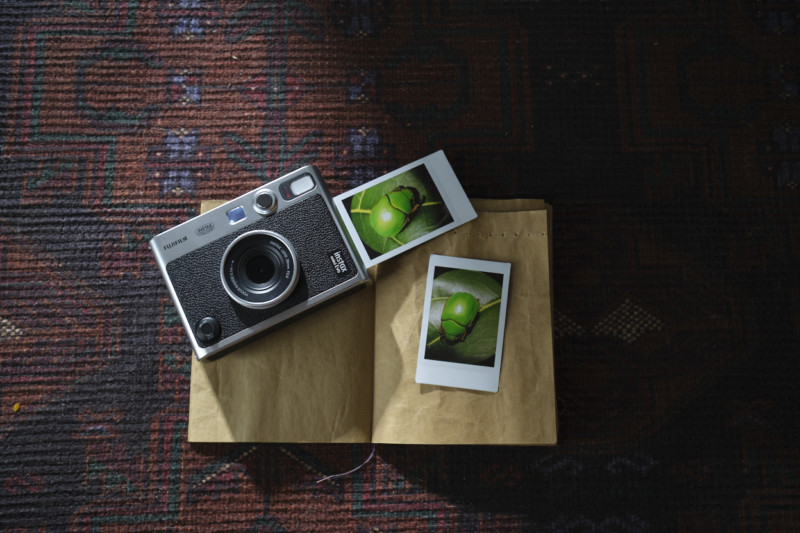 Instax mini Evo next to two photo examples