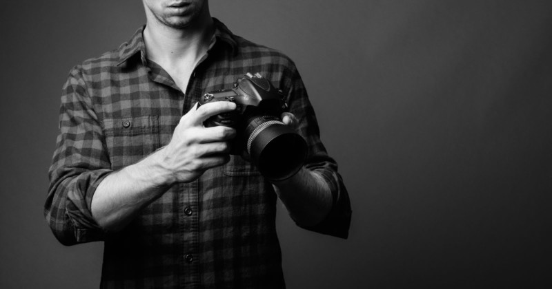 A photographer holding a camera