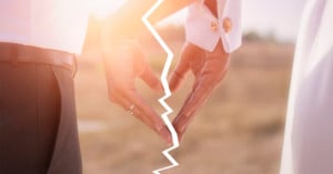 A broken photo of a newlywed couple forming a heart with their hands
